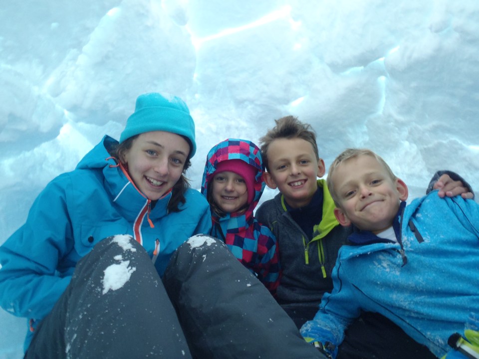 Kids enjoying the igloo they just built.